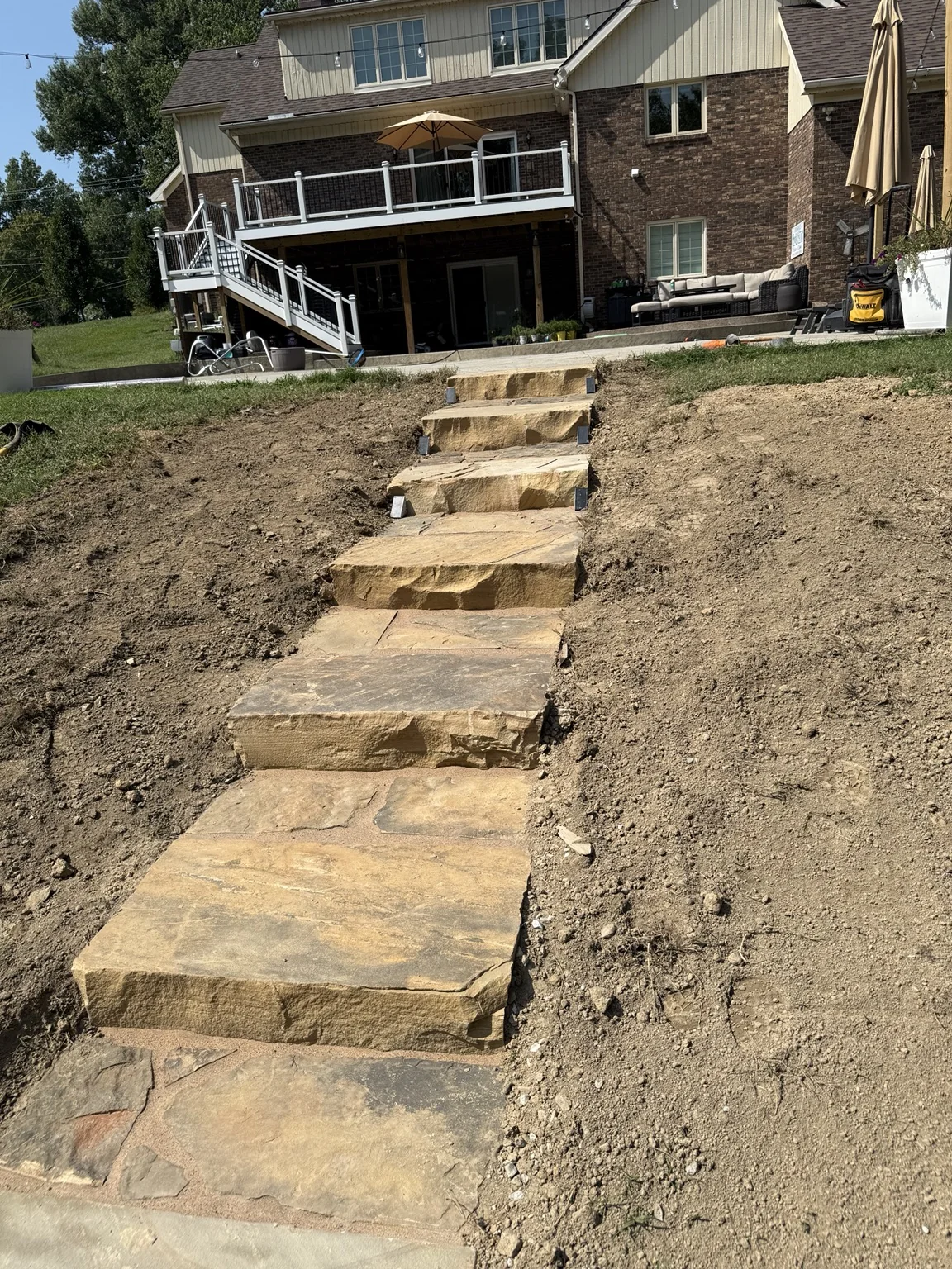 Natural stone steps installed into a sloped backyard