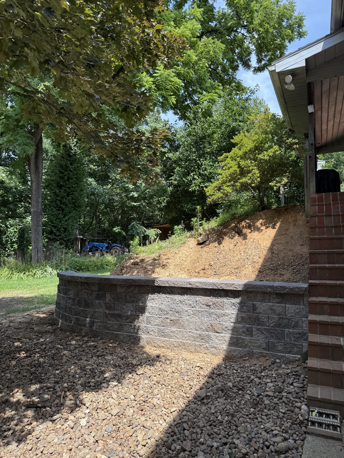 Curved block retaining wall beside brick stairs